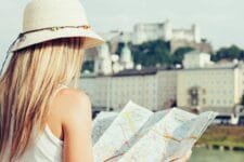 Female tourist on vacation in Salzburg Austria holding a local map