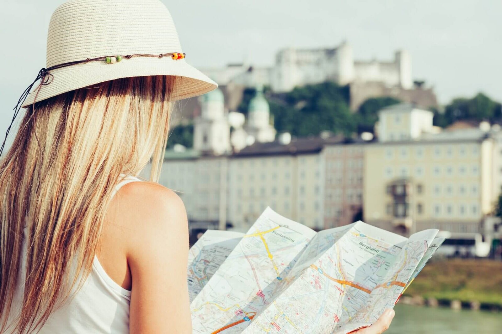 Female tourist on vacation in Salzburg Austria holding a local map