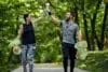 Happy couple plogging on forest path