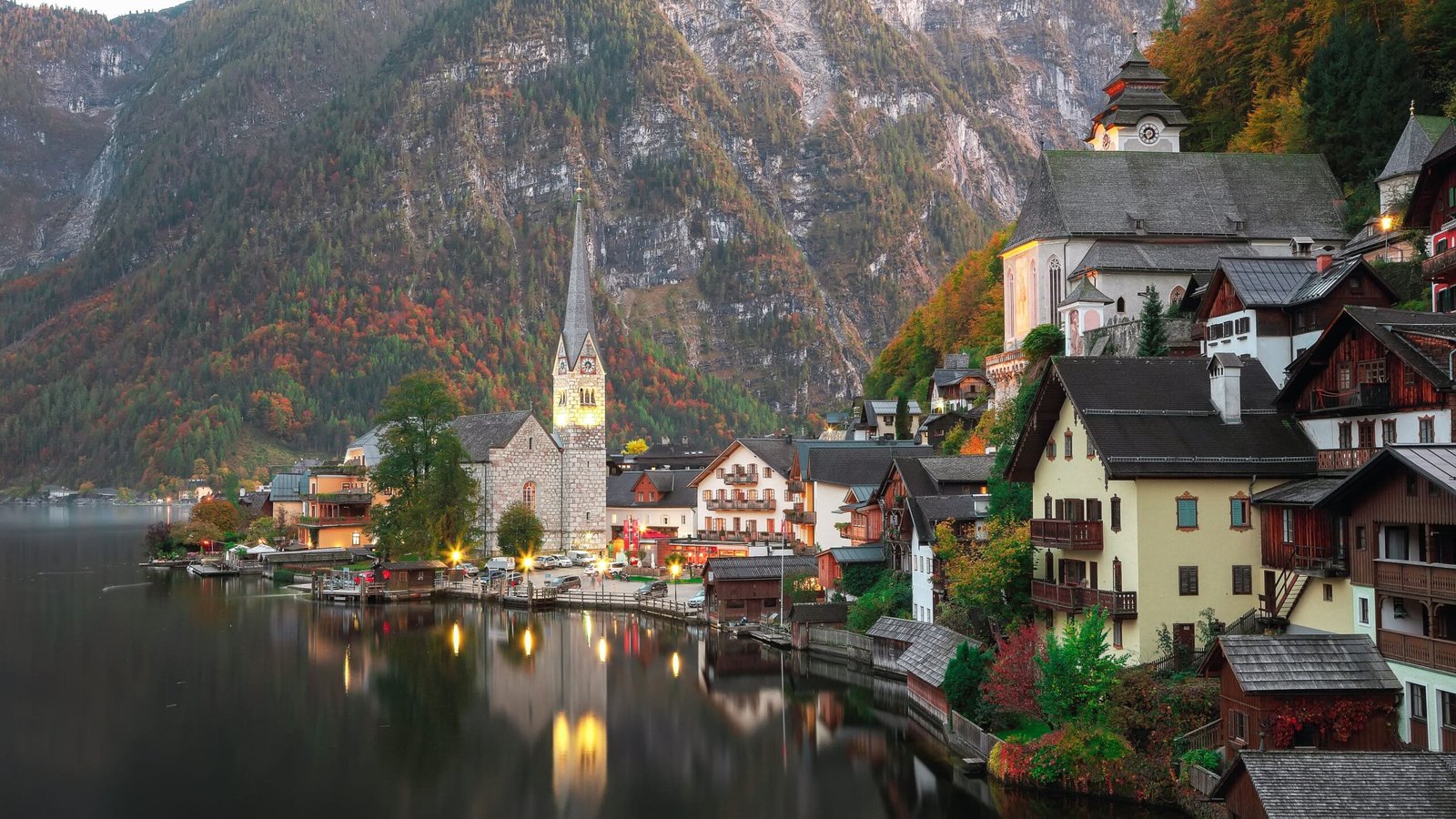 view of famous Hallstatt lakeside town reflecting in Hallstattersee lake in the Austrian Alps