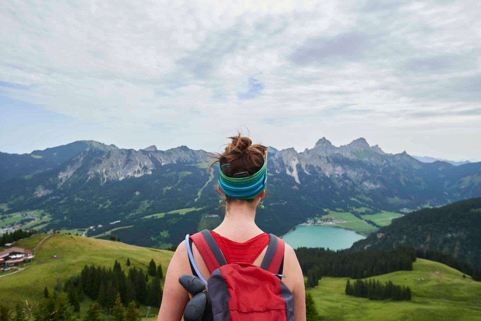 Rear view of female hiker looking out over valley in Tannheim mountains, Tyrol, Austria