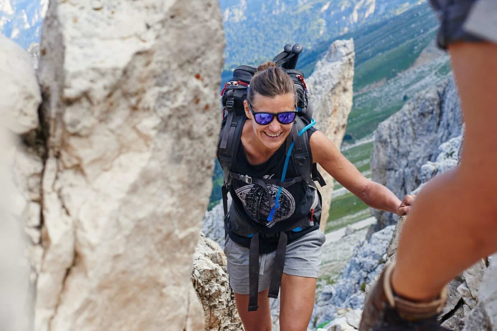 Woman hiking up mountain smiling, Austria