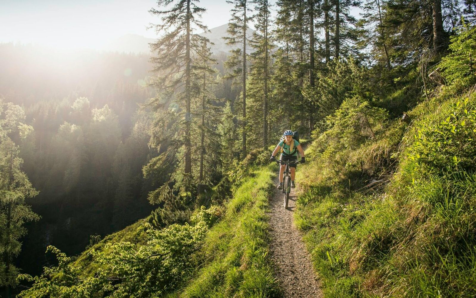 Woman mountain biking, Leermoos, Tyrol, Austria