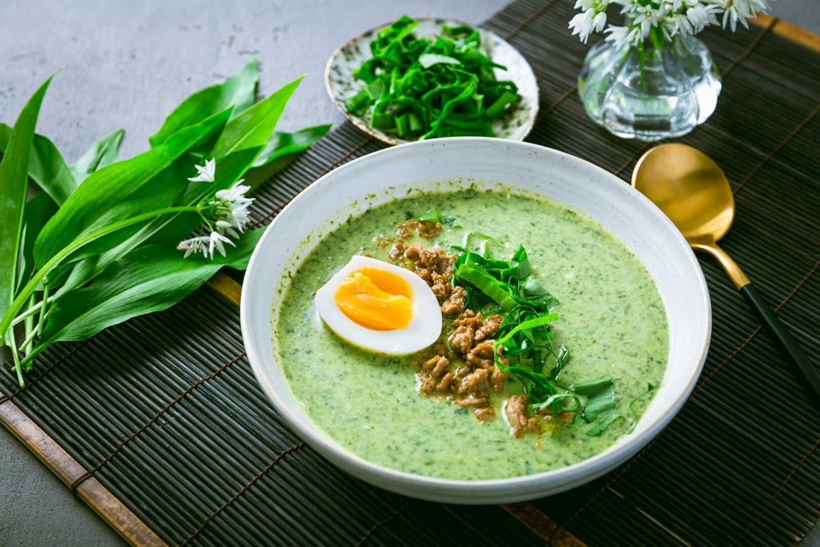 Wild garlic soup, bear leek soup (ramson soup) with boiled egg