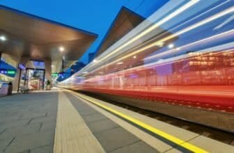 High speed train in motion on the railway station at night
