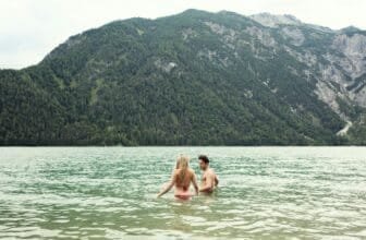 Couple waist deep in water, Achensee, Innsbruck, Tirol, Austria, Europe