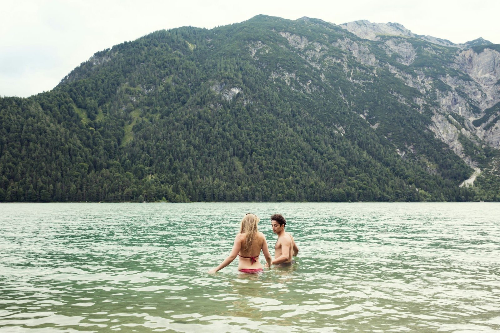 Couple waist deep in water, Achensee, Innsbruck, Tirol, Austria, Europe